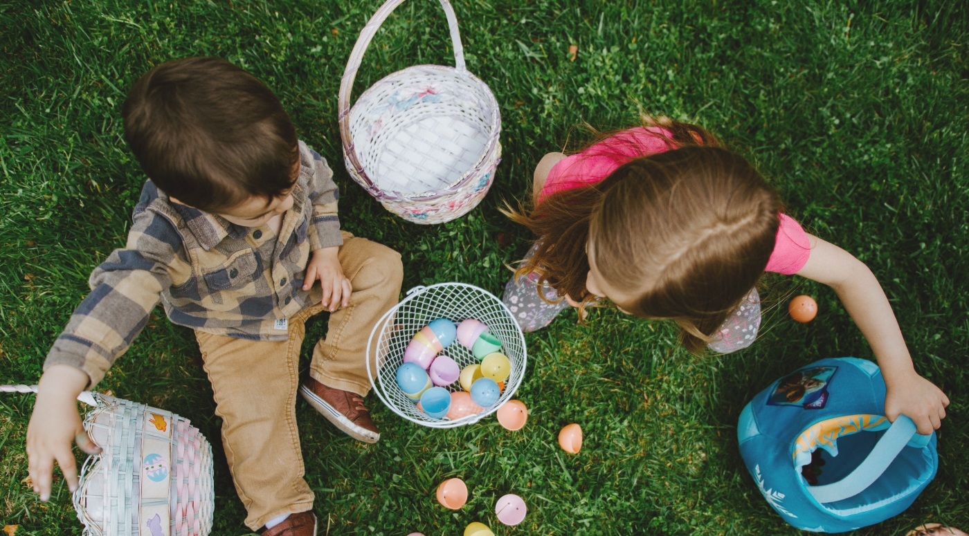 Children play with plastic easter eggs on the lawn