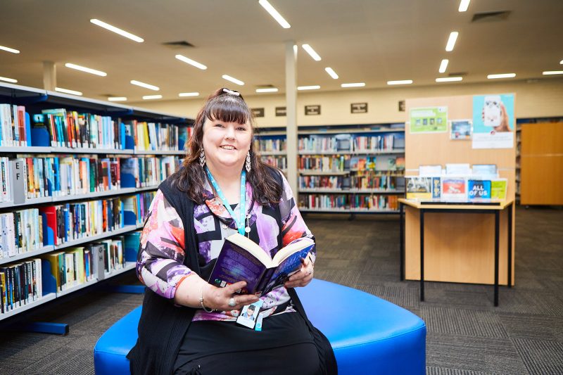 Staff member Wendy holding a book at Endeavour Hills Library